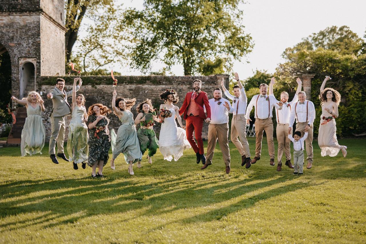 invitati matrimonio che saltano con la coppia di sposi