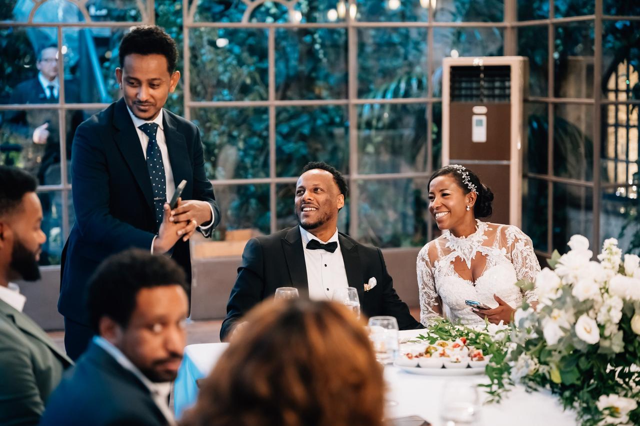 sposi con invitati matrimonio invitmo durante il banchetto nuziale