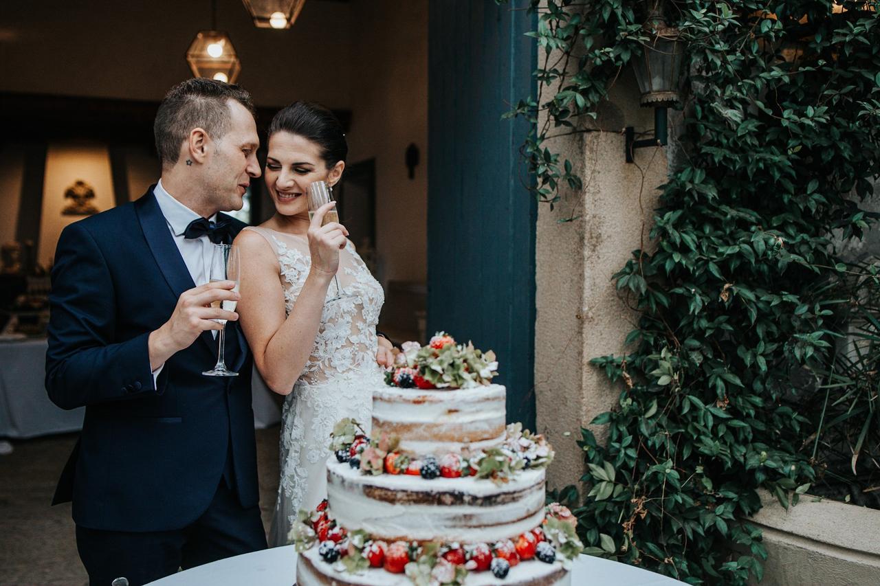 sposi che si guardano davanti alla torta nuziale autunnale