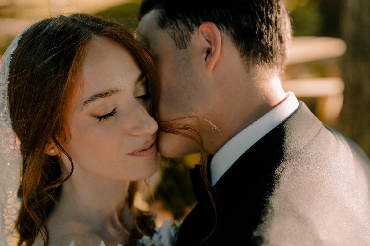 sposo che bacia sulla guancia la sposa- poesie per matrimonio