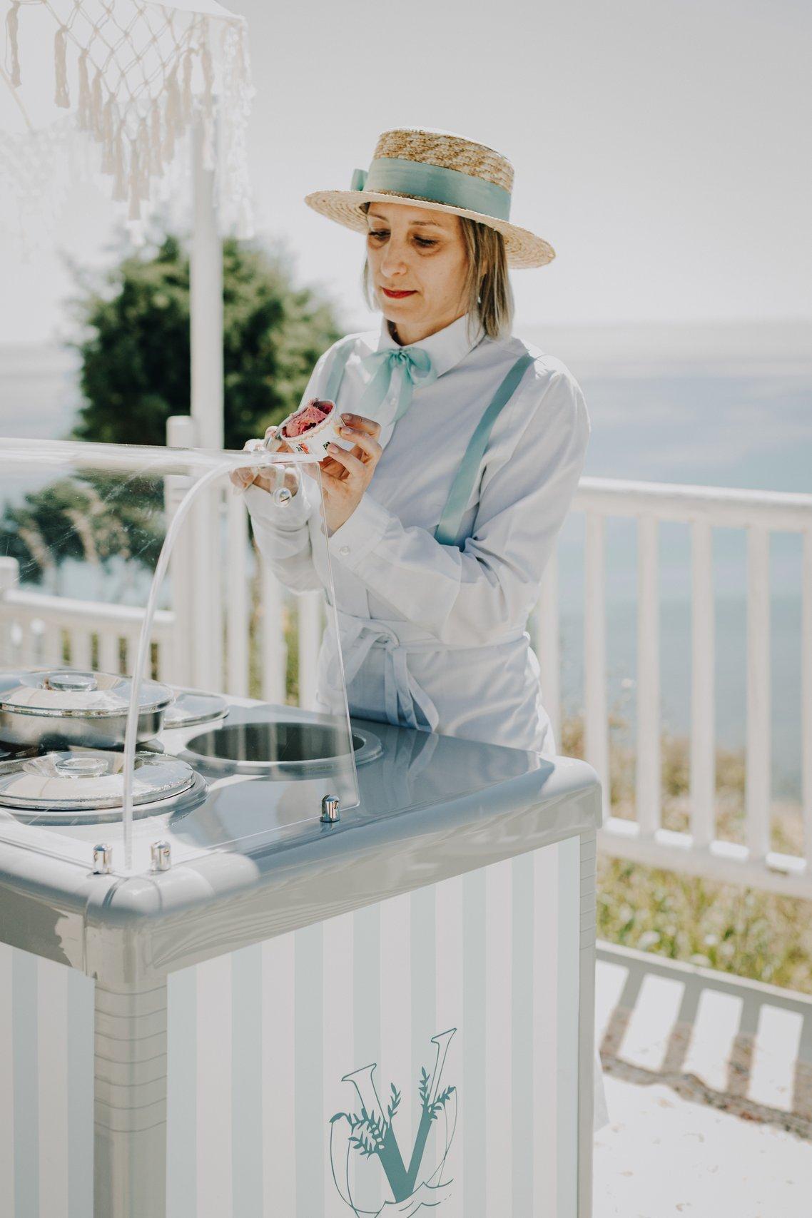 staff di una location per matrimonio che serve gelati in un carretto di gelati per matrimonio