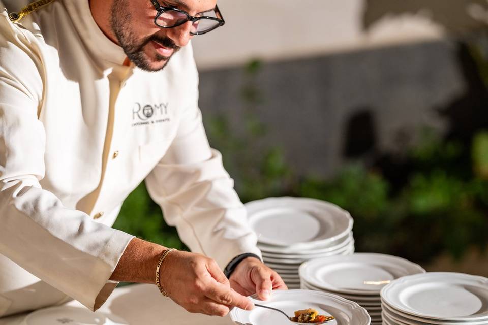 Chef che controlla i vassoi del cibo