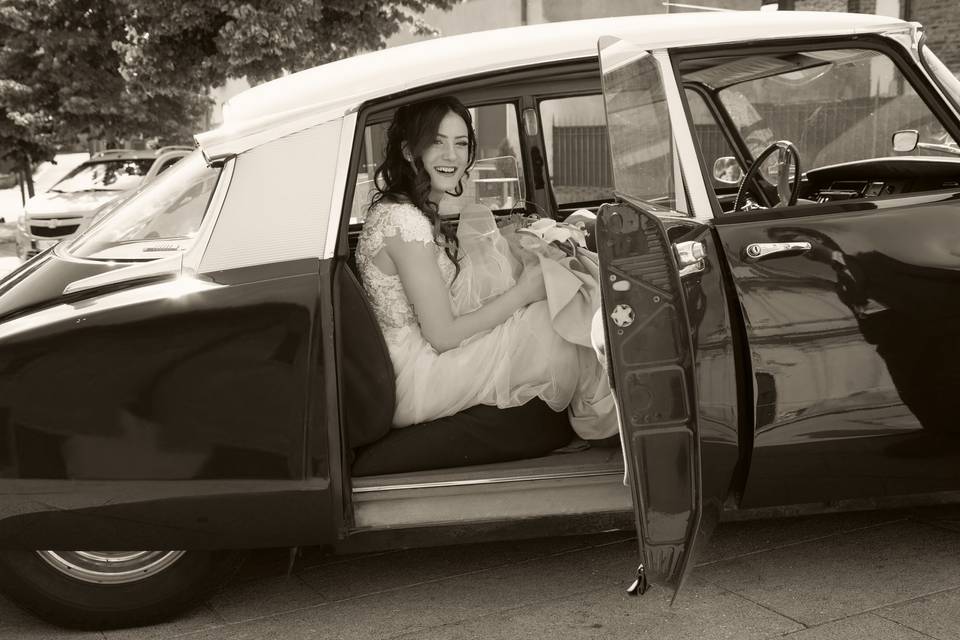 Bride on her vintage car