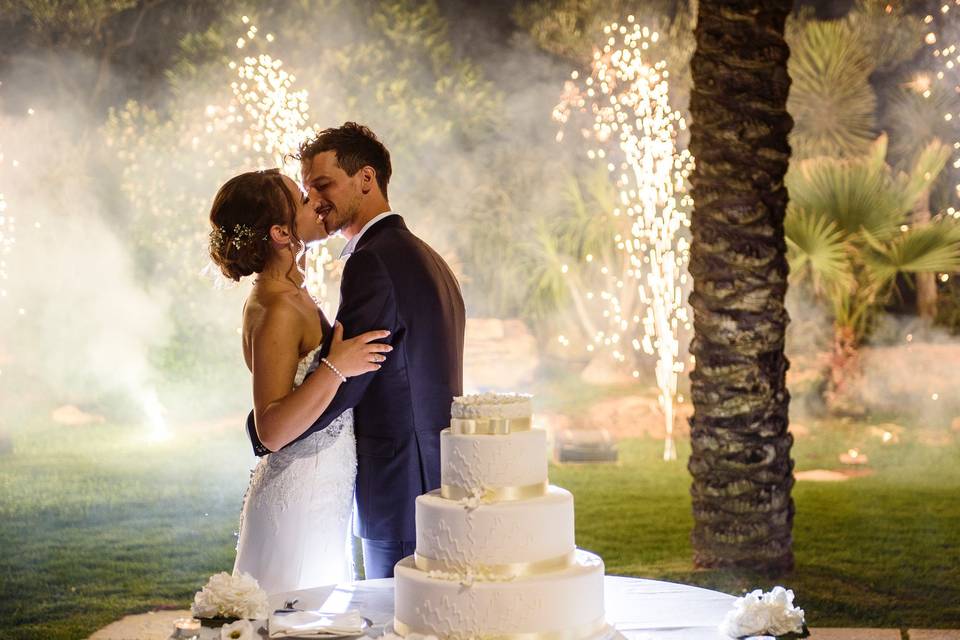 Couple with cake and fireworks